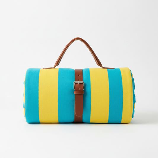 Oversized turquoise and yellow striped beach blanket rolled up with carry strap